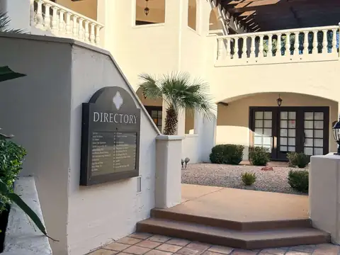 The Scottsdale office building on Via Linda: a Spanish-style courtyard with steps up to the entrance and a directory sign